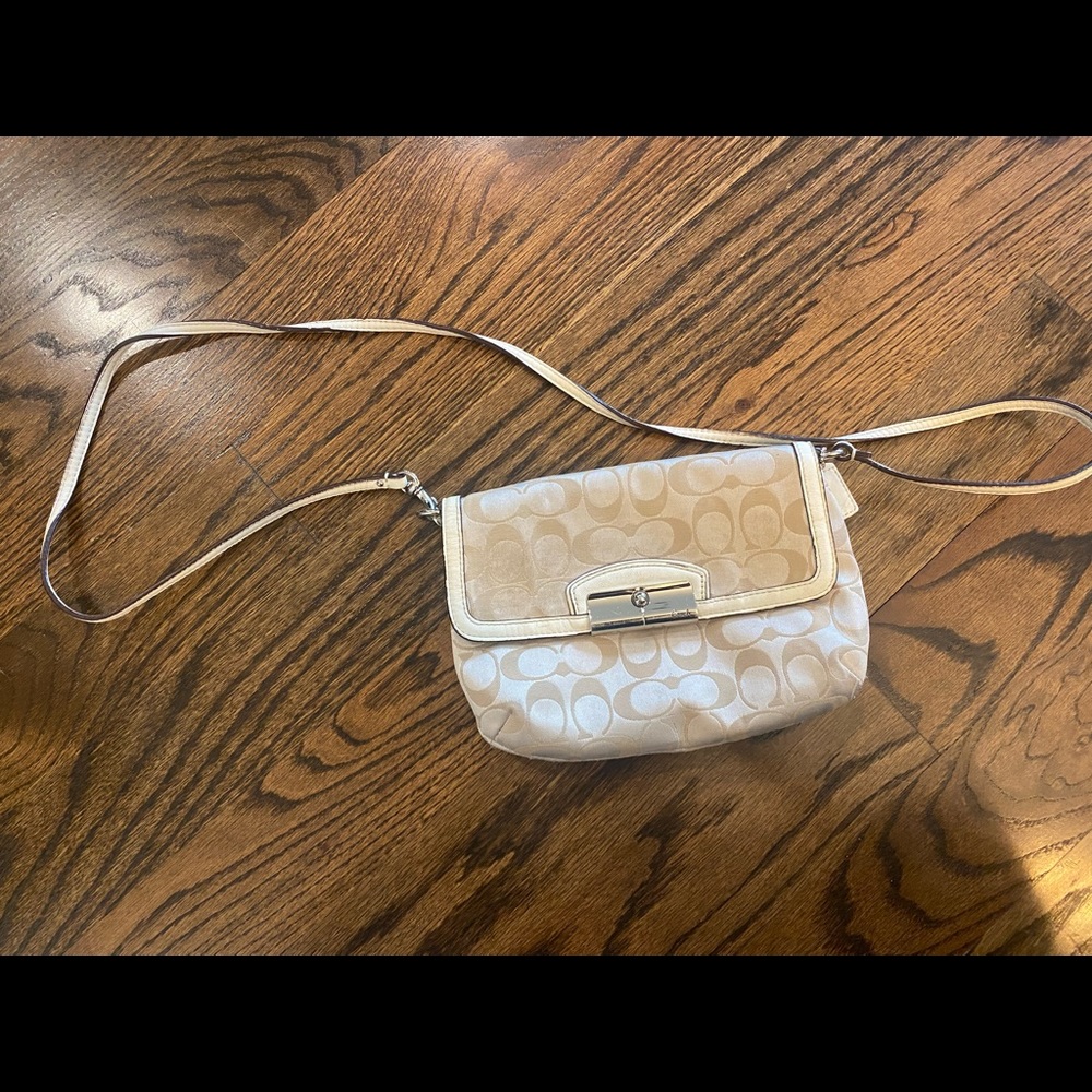Small Coach purse with strap.